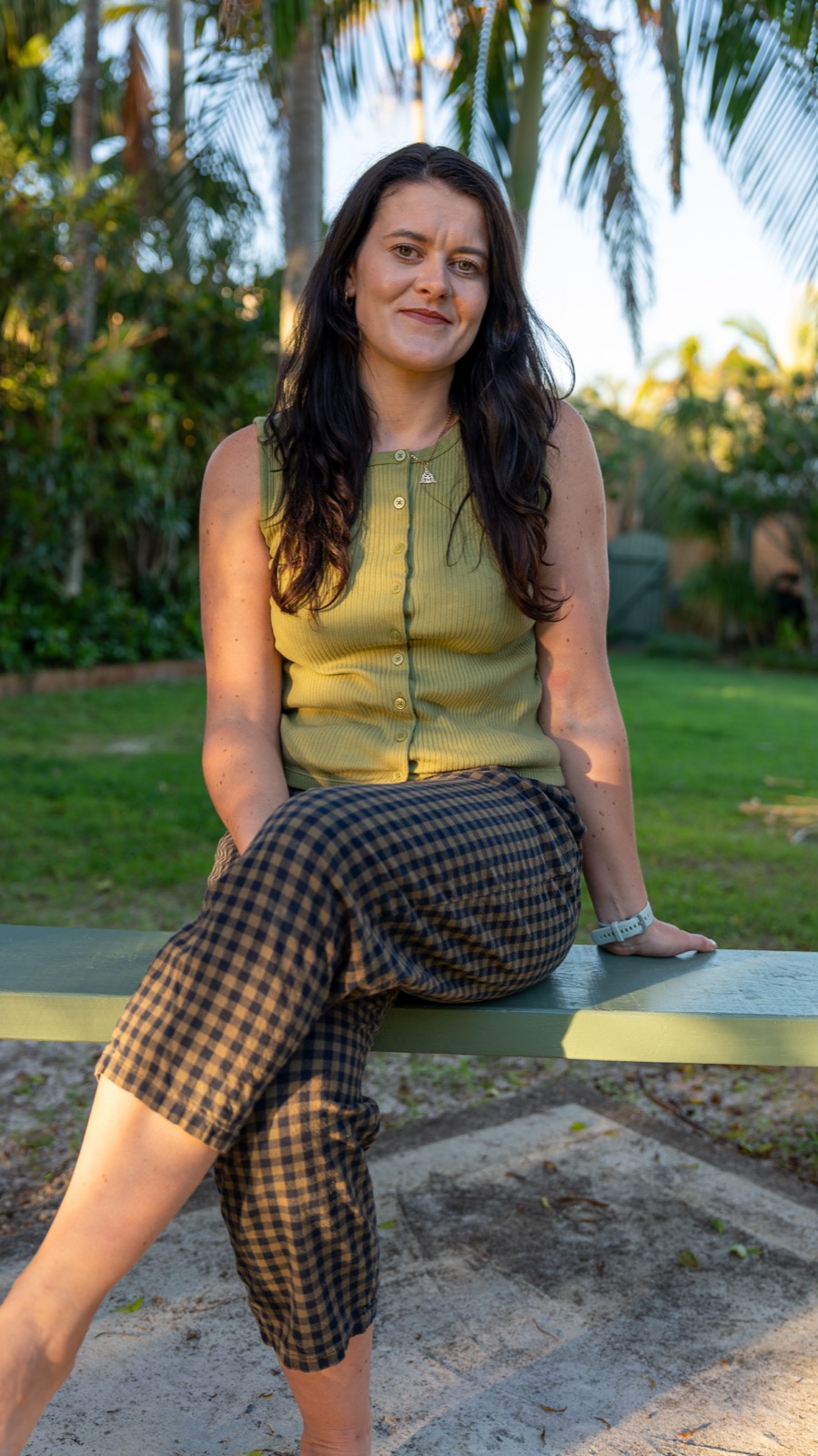 Roisin Nicholson, baby loss therapist, sitting outdoors in warm evening light in Australia